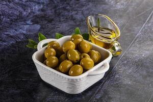 Ripe tasty green olives with branch photo