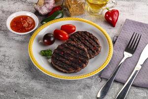 Grilled burger cutlet with sauce photo