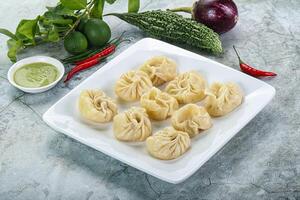 Nepali steamed dumplings Momo with sause photo