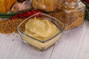 Dijon mustard sauce in the bowl photo