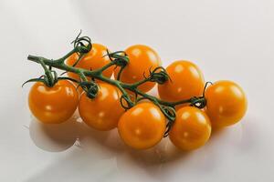 Yellow sweet tomato on the branch photo