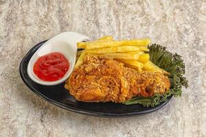 Crispy chicken leg with fry potato photo