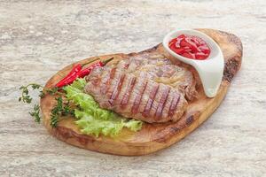 Grilled pork neck steak with ketchup photo