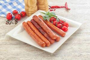 Roasted sausages in the plate photo