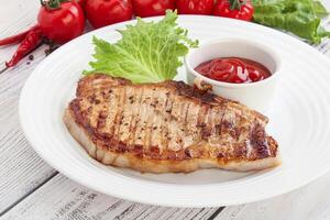 Grilled pork steak with ketchup photo