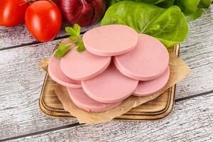 Slices boiled sausages for breakfast photo