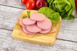 Slices boiled sausages for breakfast photo
