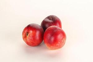 Ripe sweet juicy nectarines heap photo