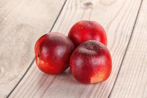 Ripe sweet juicy nectarines heap photo