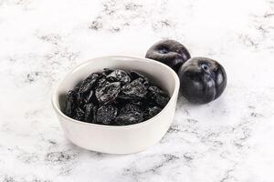 Dry prunes in thw bowl photo