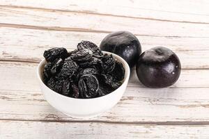 Dry prunes in thw bowl photo