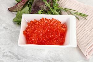 Red caviar in the bowl photo