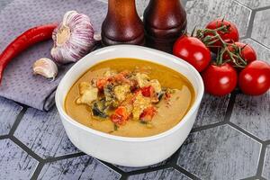 Traditional yellow Thai curry with chicken photo