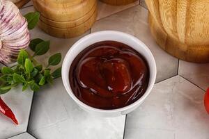 Tasty barbecue sauce in the bowl photo