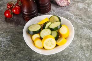 Sliced raw young green and yellow zucchini photo