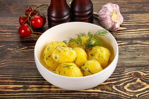 Boiled potato with oil and dill photo