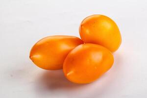 Ripe juicy yellow tomato heap photo