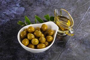 Ripe tasty green olives with branch photo