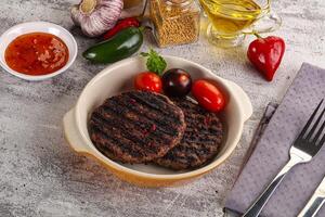 Grilled burger cutlet with sauce photo