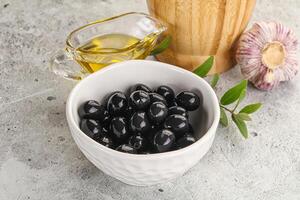 Black olives with oil and branch photo