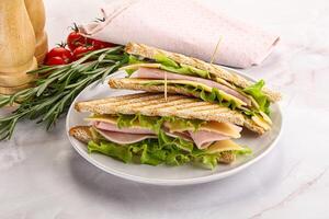 Homemade club sandwich with ham and cheese photo