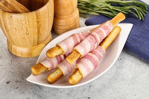 Crispy grissini italian bread with bacon photo