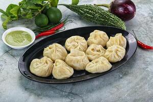 Nepali steamed dumplings Momo with sause photo