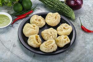 Nepali steamed dumplings Momo with sause photo