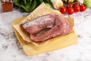 Uncooked raw pork tenderloin with spices photo