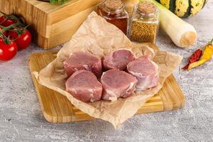 Uncooked raw pork tenderloin medallions photo