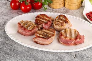 Grilled pork tenderloin with bacon photo