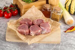 Uncooked raw pork tenderloin medallions photo