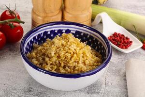 Boiled bulgur wheat in the bowl photo