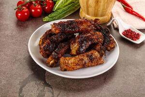 Grilled pork ribs in barbecue sauce photo