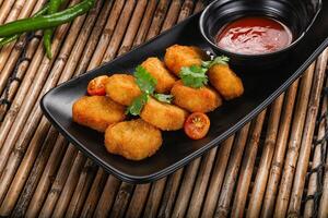 Crispy golden choclen nuggets with sauce photo