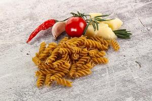 Raw whole grain pasta fusilli photo