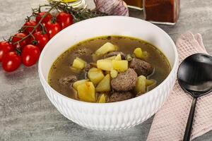 Soup with meatball and potato photo