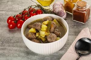 Soup with meatball and potato photo