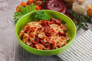 Italian pasta with dry tomato photo