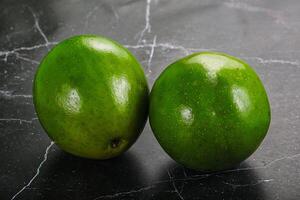 Two ripe green exotic avocado fruit photo