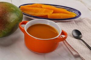 Sweet mango puree in the bowl photo