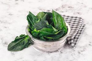 Ripe green spinach leaves heap photo