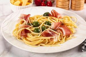 Pasta spaghetti with olives and jamon photo