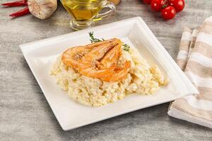 Italian risotto with prawn served thyme photo