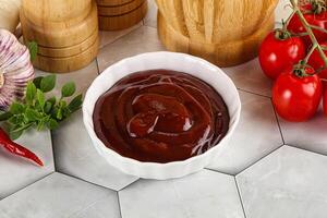 Tasty barbecue sauce in the bowl photo