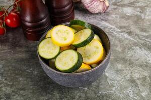 Sliced raw young green and yellow zucchini photo