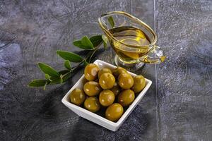 Ripe tasty green olives with branch photo