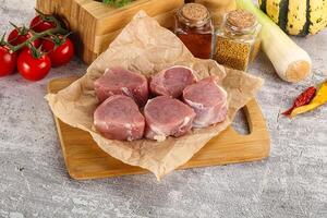 Uncooked raw pork tenderloin medallions photo