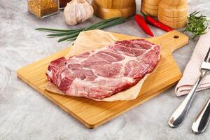 Raw pork neck steak for grill photo