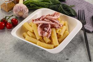 Italian cuisine - pasta tortiglioni with squid photo